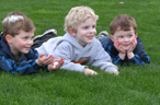 healthy lawn with kids lying in grass
